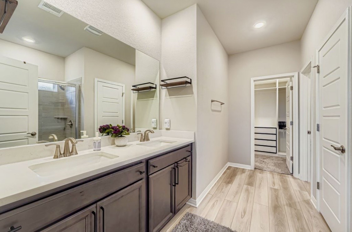 A clean double-vanity bathroom at HIS House