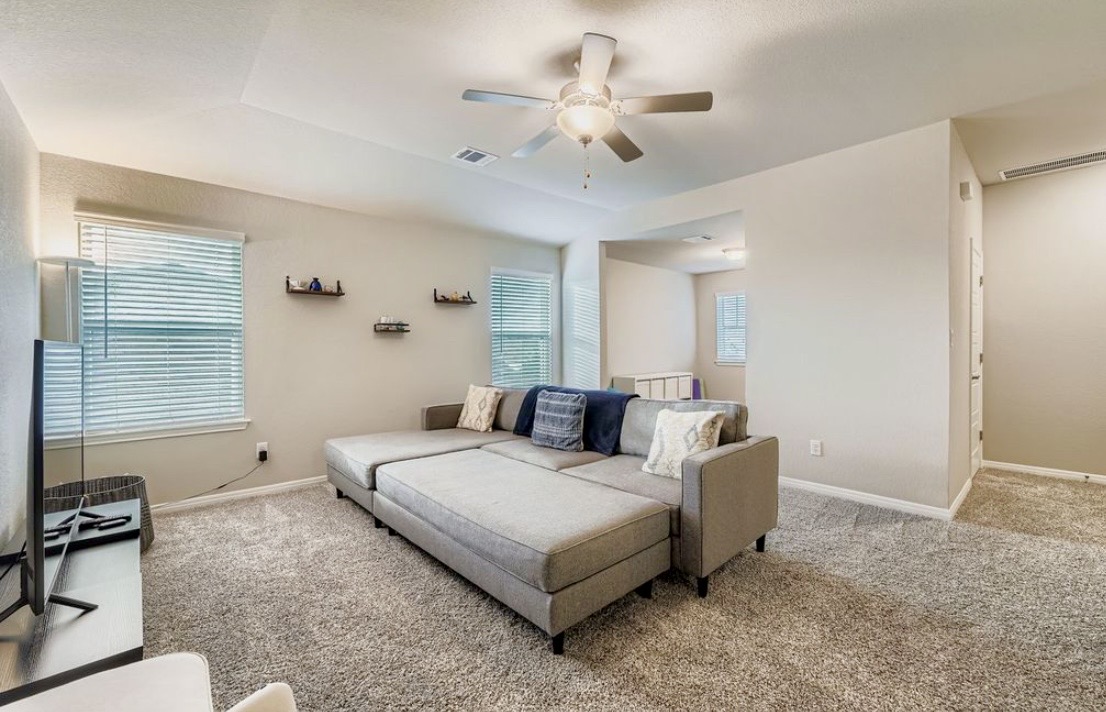The upstairs hangout room with a big sectional and TV