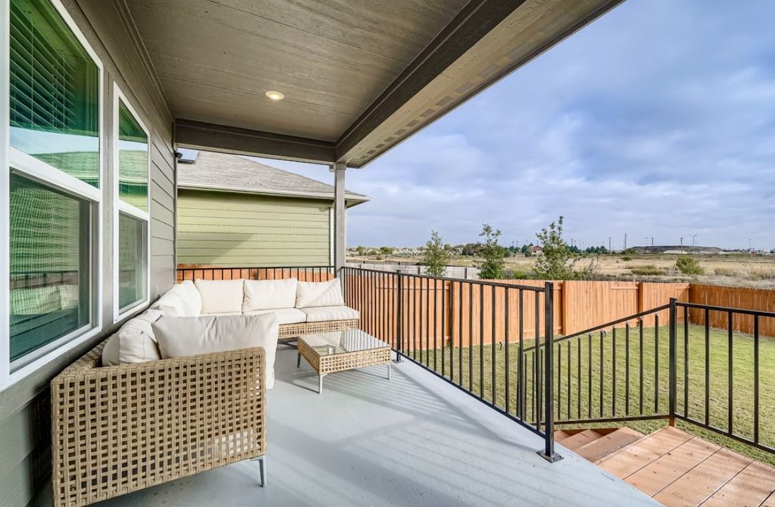 The covered back patio at HIS House with outdoor lounge seating